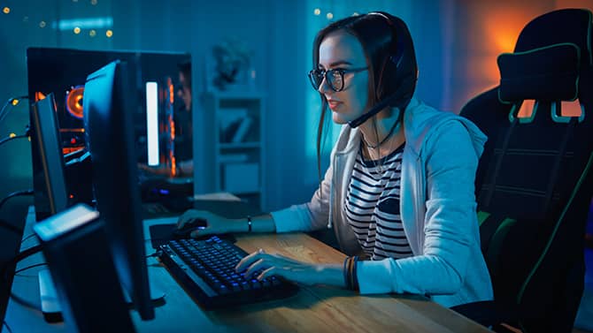 Una donna intenta a giocare online. I videogiochi sono divertenti, ma è importante tenere in considerazione la sicurezza del gaming online.